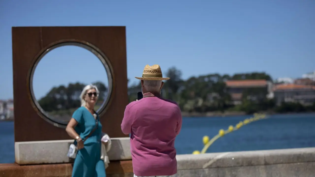 Un hombre echa una foto a una mujer en el paseo mar&iacute;timo - Beatriz Ciscar / Europa Press